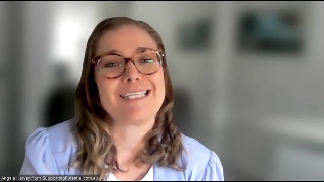 Angela Harvey, smiling, speaking to camera