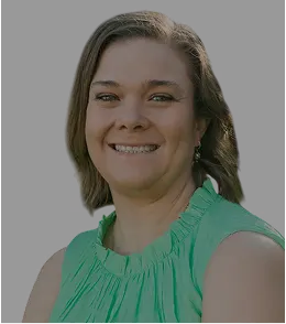 Angela, smiling, in a green top