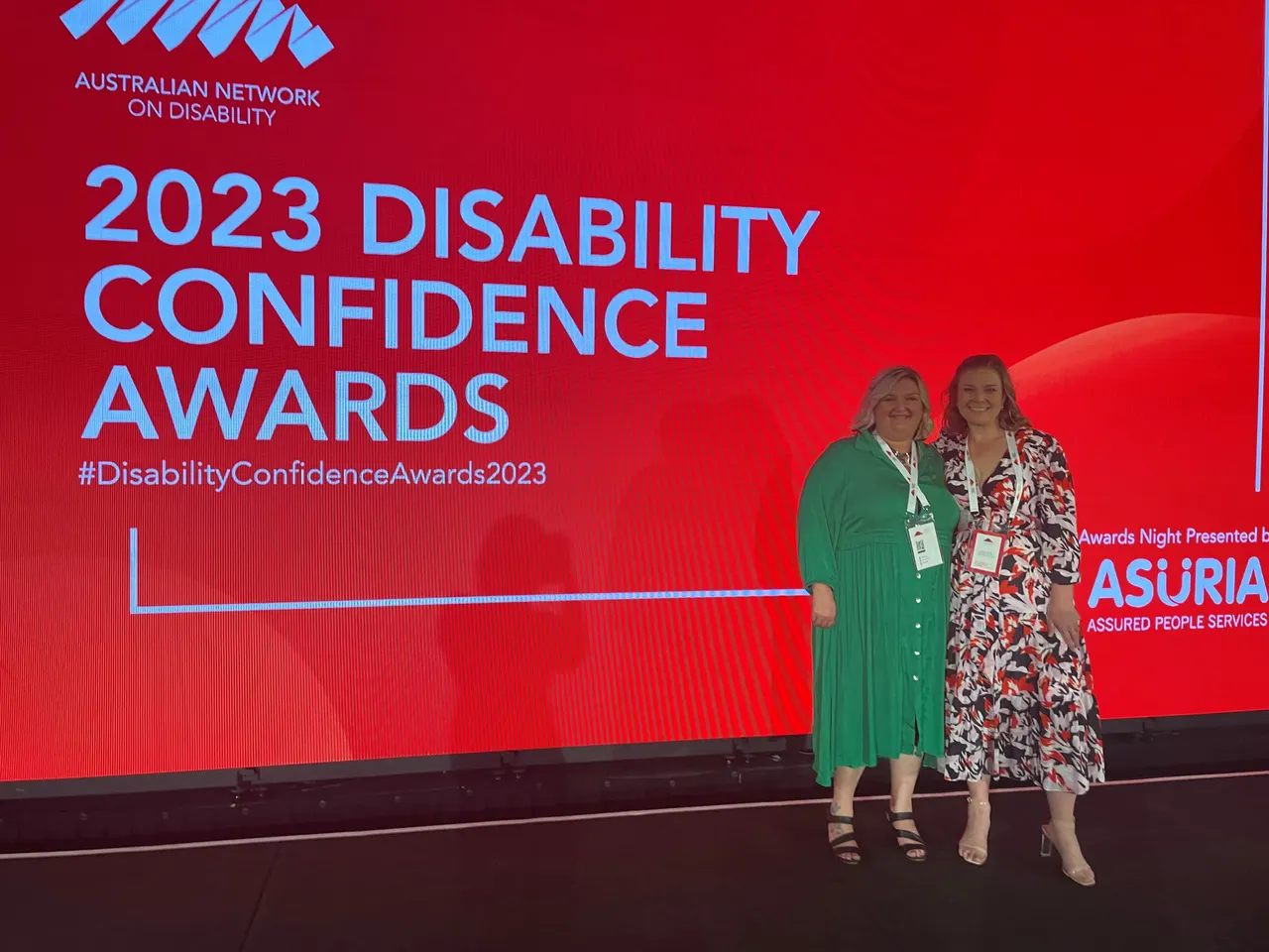 Two team members on stage at the 2023 Disability Confidence Awards, Australian Network on Disability